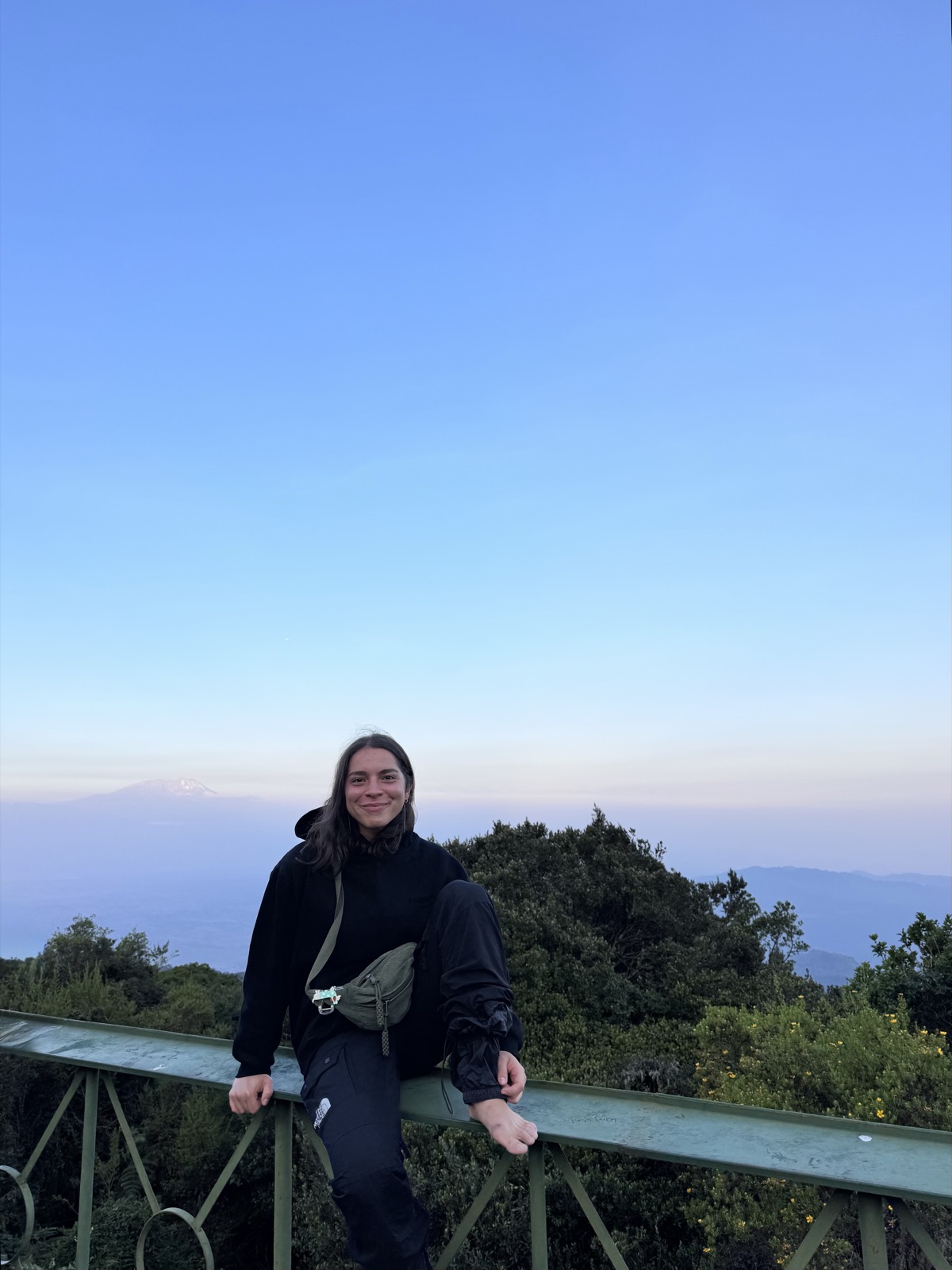 Ioana at a viewpoint on Mt Meru in Tanzania, at dawn.